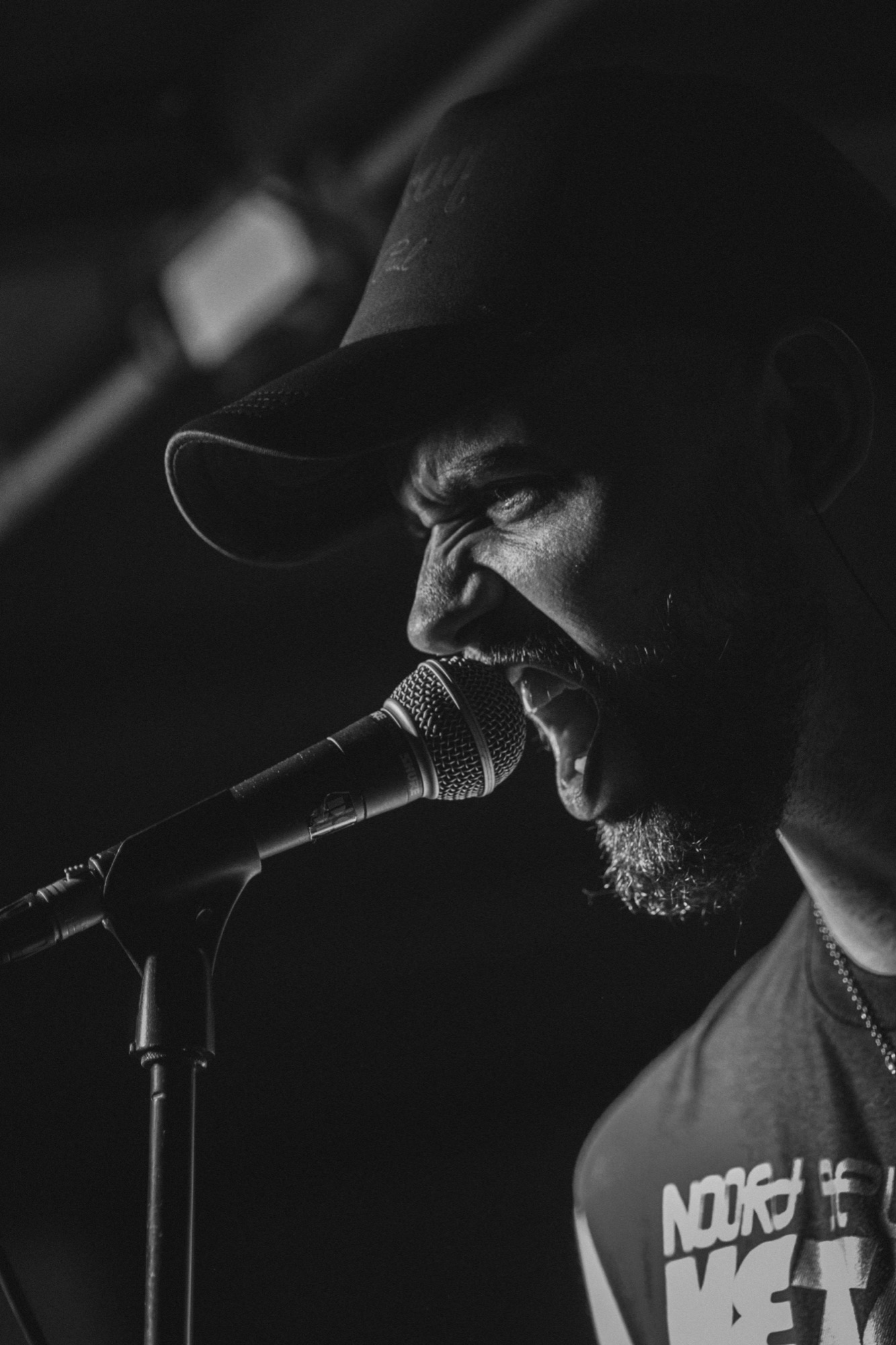 Vocalist at a microphone in black and white