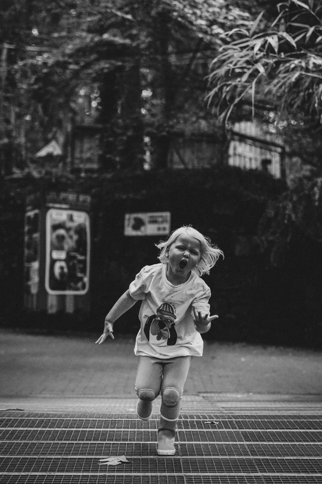 Child running towards the camera in black and white