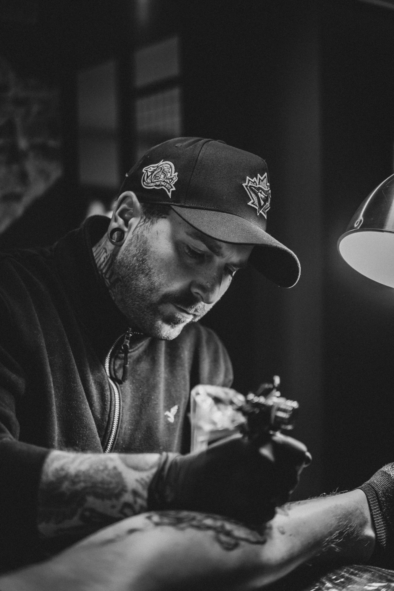 Tattoo artist concentrating while working in his studio